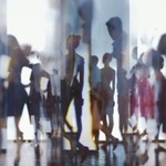 Blurred image of lots of people standing in an enclosed space