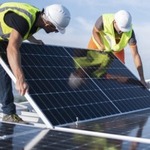 Construction workers setting up a solar panel
