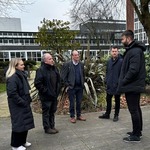 Mike Kane MP and academics standing outside the University of Manchester